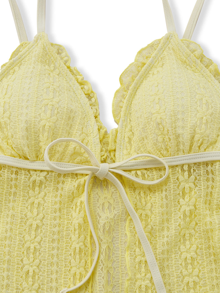 Yellow lace bra with a bow on a white background