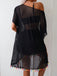 Black off-shoulder dress with colorful tassels on a plain background