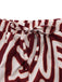 Red and white patterned shorts with a tie waist on a white background