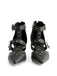 Pair of black studded high-heeled shoes on a white background