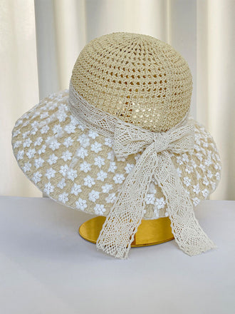 Chapeau de soleil beige orné de dentelle florale blanche sur fond blanc