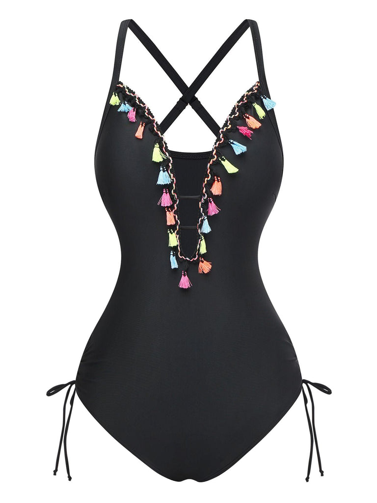 Un maillot de bain une pièce noir doté d'un décolleté en V profond orné de pompons colorés et de détails à nouer sur les côtés.