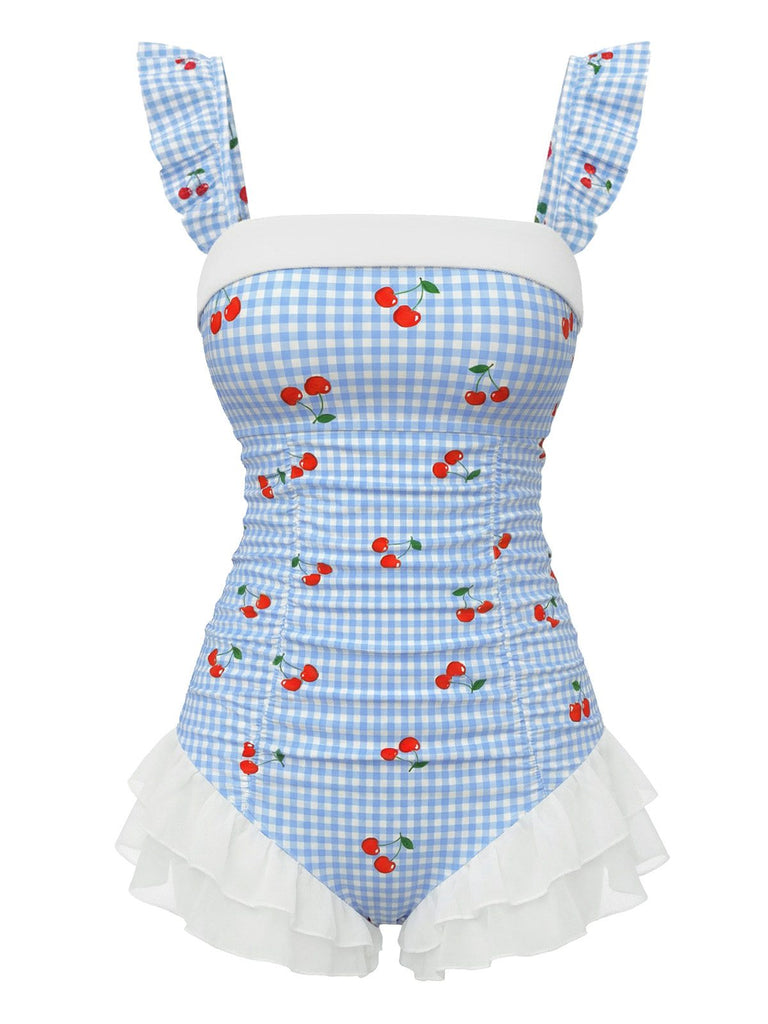 Maillot de bain une pièce bleu vintage à carreaux cerises et superposition de tulle à volants romantique, parfait pour un look de plage inspiré des pin-up des années 50