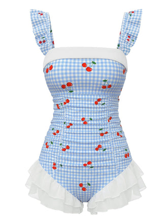 Maillot de bain une pièce bleu vintage à carreaux cerises et superposition de tulle à volants romantique, parfait pour un look de plage inspiré des pin-up des années 50