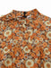Combinaison orange col noué en velours côtelé motif marguerites années 1970