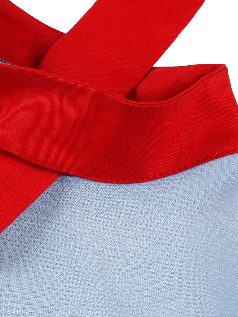 Robe bleue col montant et nœud contrastant années 1950