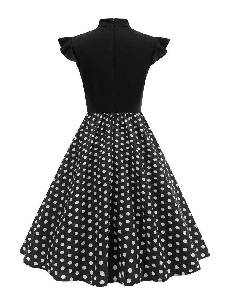 Robe noire trapèze à pois col nœud manches cape années 1950