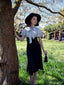 Robe sirène noire à pois et col noué des années 1930