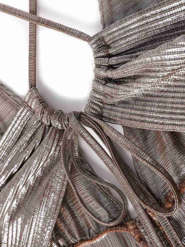 Close-up of a metallic fabric with intricate patterns and textures.
