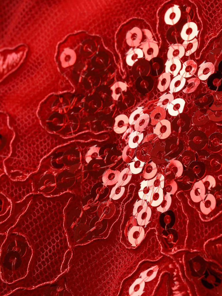 Close-up of the intricate floral lace pattern on the red mesh fabric, highlighting the fine craftsmanship.