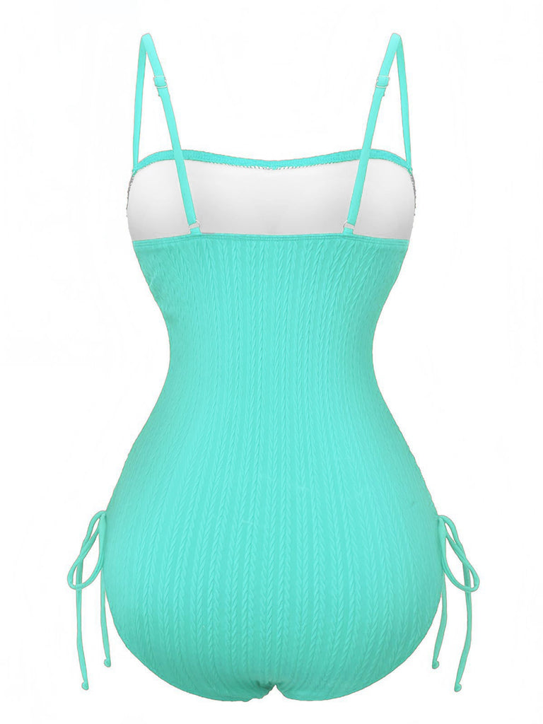 Turquoise swimsuit with white top on a white background