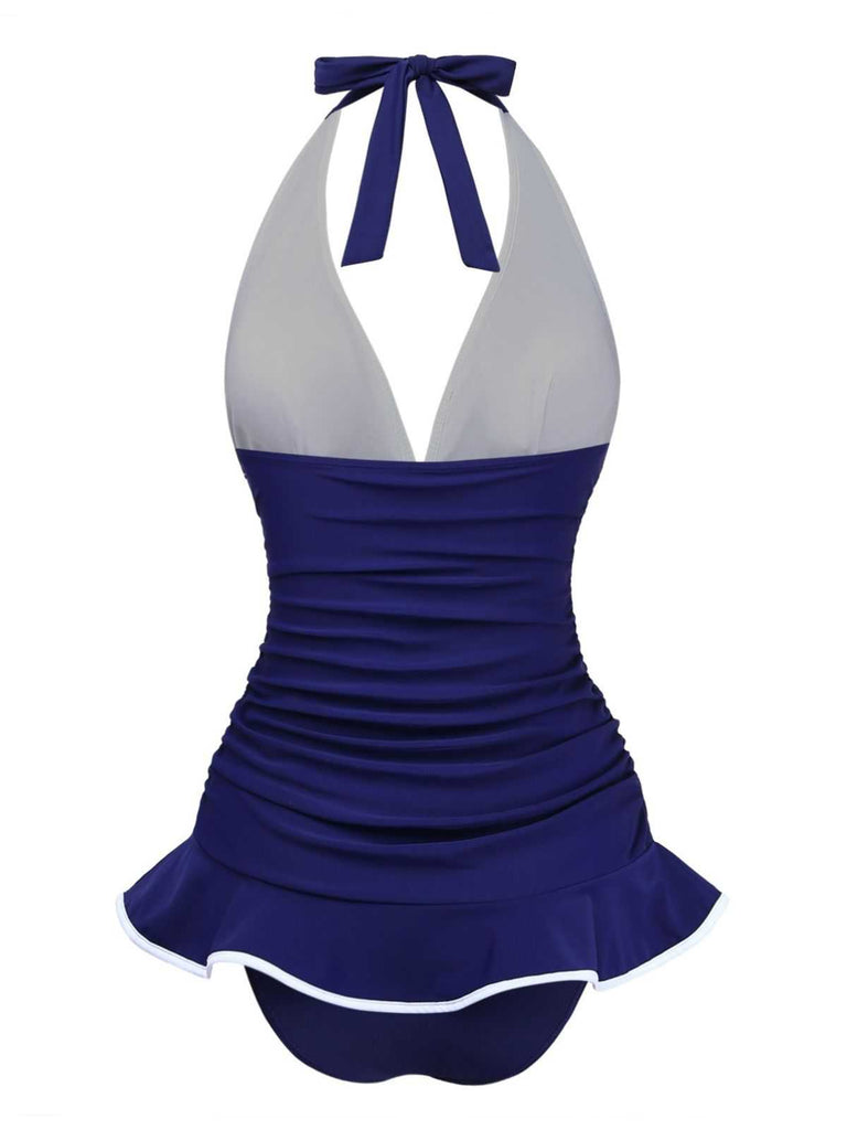 Back view of the navy blue skirted swimsuit, showing the comfortable fit and elegant silhouette.