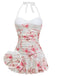 A white one-piece swimsuit featuring a pink rose print, vintage cursive script, a sweetheart neckline, and an attached ruffled swim skirt.