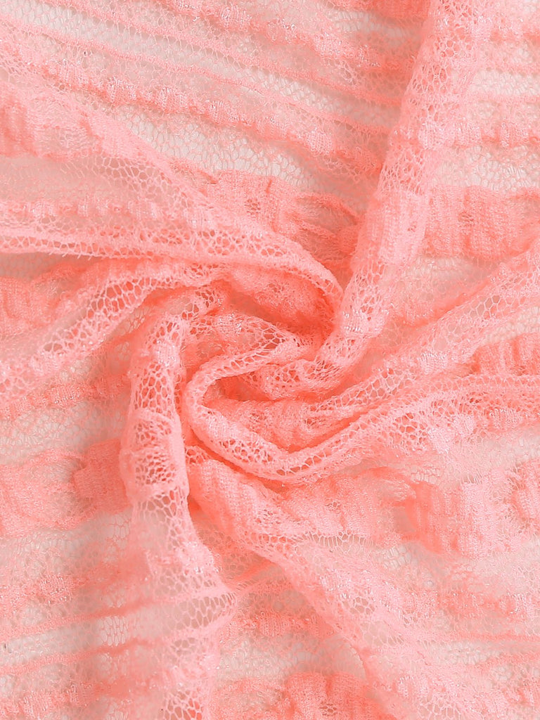 Macro shot of the intricate floral lace fabric used for the bell-sleeve swim cover-up.