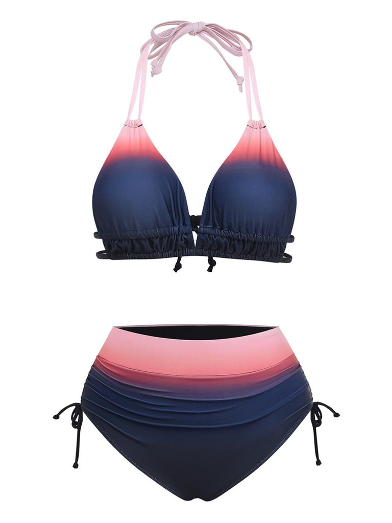 A two-piece bikini set featuring a pink-to-navy blue ombre gradient, including a halter-neck top with ruffled trim and high-waisted bottoms with side-tie details.