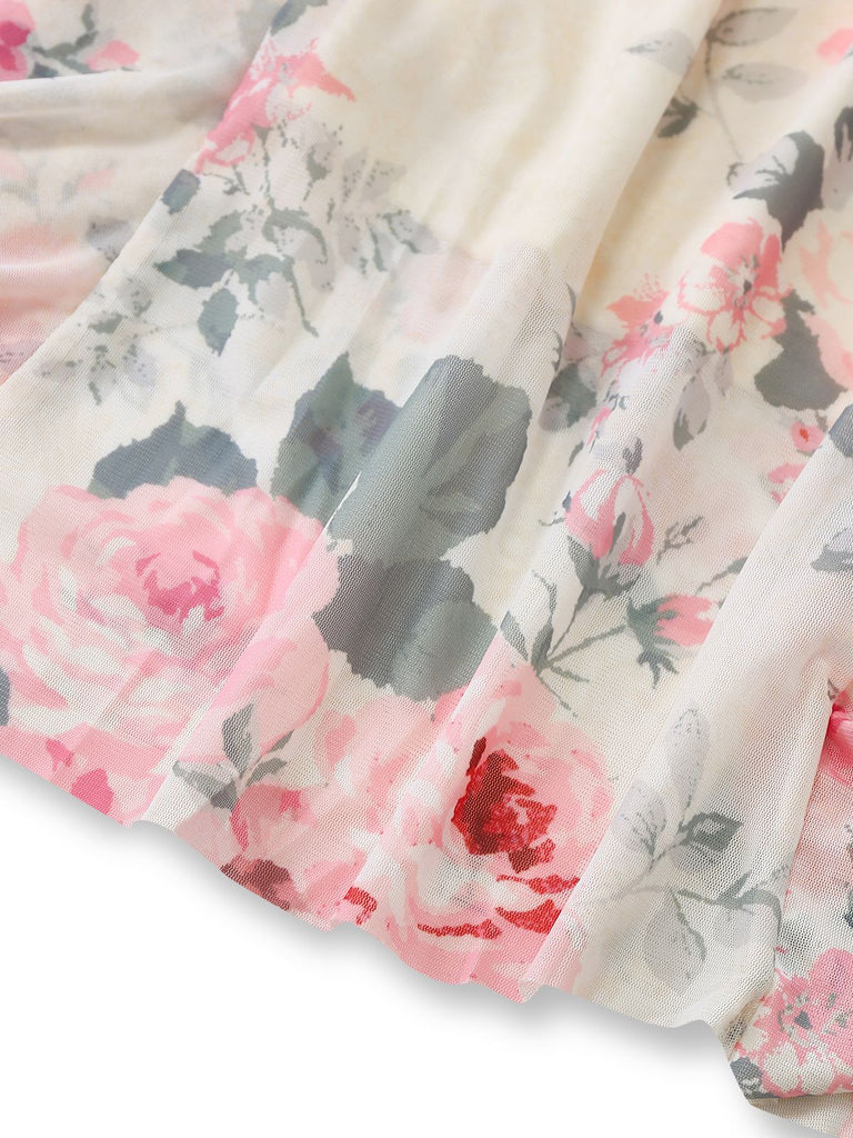 Detail shot of the lightweight fabric draped to show the vibrant pink and grey rose floral pattern.