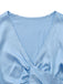 Close-up of the elegant deep V-neckline and smooth satin fabric of the light blue cropped lounge top