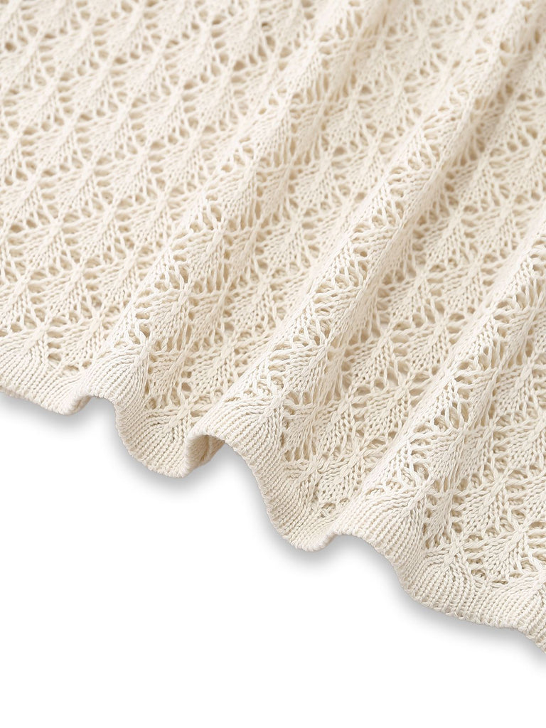 A close-up showing the hemline and detailed knit craftsmanship of the cream crochet cover-up.