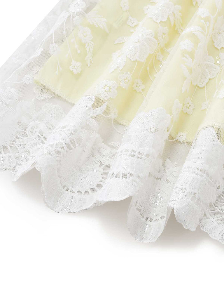 Detailed view of the bottom hem of the dress featuring a delicate scalloped white lace trim.